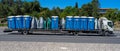 freight truck transporting portable blue toilets.