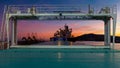 On a freighter in port at sunset. In the foreground are the covered holds. Royalty Free Stock Photo