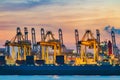 Freighter ship loading cargo at loading dock on twilight time.