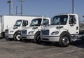 Freightliner Semi Tractor Trailer Big Rig Trucks lined up for sale. Freightliner is owned by Daimler Trucks