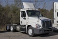 Freightliner Semi Tractor Trailer Truck lined up for sale. Freightliner is owned by Daimler Trucks