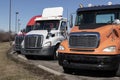 Freightliner Semi Tractor Trailer Trucks Lined up for sale. Freightliner is owned by Daimler