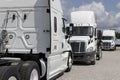 Freightliner Semi Tractor Trailer Trucks Lined up for sale. Freightliner is owned by Daimler