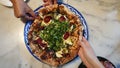 Freinds hands taking slice of pizza top view party food