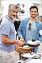 freinds men on outdoor market buyin kitchen tool Royalty Free Stock Photo