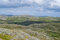 Freita mountain range highland. Rocky landscape with clouds. Hills with yellow and green vegetation