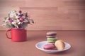 Frence sweet delicacy macaroons and white coffee cup on wood background Royalty Free Stock Photo