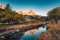 French Alps landscape of sunrise over Claree valley and river flowing in larch forest during autumn at France Royalty Free Stock Photo