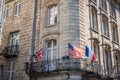 French, American and English flags on the balcony of a Bordelais building Royalty Free Stock Photo