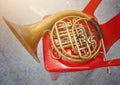 French antique rust horn instrument Put on a red chair