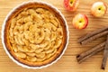 French apple tart aside Gala apples and cinnamon sticks on oak wood background. Flat lay. Top view Royalty Free Stock Photo