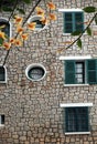 French architecture of ancient stone house with green wooden window and door at Da Lat Royalty Free Stock Photo