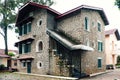 French architecture of ancient stone house with green wooden window and door at Da Lat Royalty Free Stock Photo