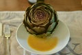 French artichoke on a plate with vinaigrette Royalty Free Stock Photo