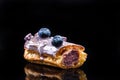 French Artisan Eclair on Black Reflective Background,Copy Space