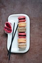 French assorted macarons cakes on a rectangular dish. Colorful Small French cakes.
