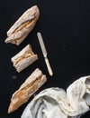 French baguette broken into pieces, white kitchen towel and vint Royalty Free Stock Photo