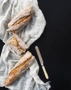 French baguette broken into pieces on a white kitchen towel with Royalty Free Stock Photo