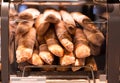 French Baguettes in bakery store. Freshly baked loaves on bakery racks. Royalty Free Stock Photo