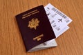 French biometric passport with a plane ticket in it on a wooden table
