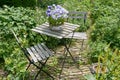 French bistro table and chairs in a garden Royalty Free Stock Photo