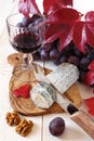 French blue cheese, walnuts, grapes and a wineglass Royalty Free Stock Photo