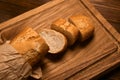 French bread baguette cut on vintage wooden bread board with knife Royalty Free Stock Photo