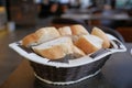 French bread baguettes in wood basket on cafe table Royalty Free Stock Photo