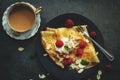 French Breakfast Crepes served with Raspberries on dark moody background