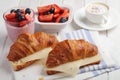 French breakfast: croissant sandwich with cheese, fruit salad, chia seeds yogurt, and coffee Royalty Free Stock Photo