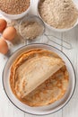 French buckwheat crepes gluten free and with a lovely slightly nutty flavor closeup on the white wooden table. Vertical top view Royalty Free Stock Photo
