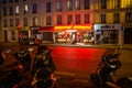 French cafe with tables outdoor in Paris and blurred moving woman on bicycle