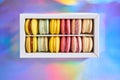 French cake macaron. Set of cute sweets on colorful rainbow background. almond cookies, pastel colors, top view Royalty Free Stock Photo