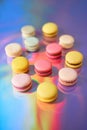 French cake macaron. Set of cute sweets on colorful rainbow background. almond cookies, pastel colors, top view Royalty Free Stock Photo