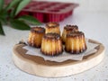 French caneles on a wooden board. Still life with a small pastry flavored with rum known as CanelÃÂ¨ De Bordeaux Royalty Free Stock Photo