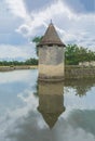 French castle. Fortress tower in the middle of the lake