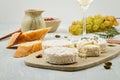French cheese plate and a glass of wine for buffet party. Traditional french and italian entires Royalty Free Stock Photo