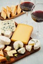 French cheese plate and a glass of wine for buffet party. Traditional french and italian entires Royalty Free Stock Photo