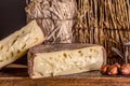 French cheese Saint Nectaire rustic collection delicious. Black background.