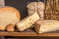 French cheese Saint Nectaire rustic collection delicious. Black background.