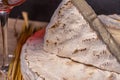 French cheese Saint Nectaire rustic collection delicious with a glass of wine. Black background.