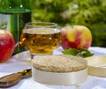 French cheeses collection, piece of fermented cow milk cheese Camembert au Calvados served with French dry apple cider outside in