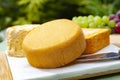 French cheeses collection, yellow Riche de Saveurs and Le peche des bons peres cheeses served on white marble plate outdoor in Royalty Free Stock Photo