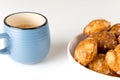 french chouquettes puffs with perles of sugar on plate with blue cup of coffee. Choux pastry Classic French bakeries.