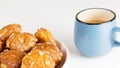 french chouquettes puffs with perles of sugar on plate with blue cup of coffee. Choux pastry Classic French bakeries. Royalty Free Stock Photo