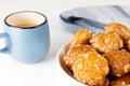 french chouquettes puffs with perles of sugar on plate with blue cup of coffee. Choux pastry Classic French bakeries. Royalty Free Stock Photo