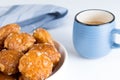 french chouquettes puffs with perles of sugar on plate with blue cup of coffee. Choux pastry Classic French bakeries. Royalty Free Stock Photo