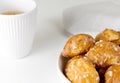 french chouquettes puffs with perles of sugar on plate with white cup of coffee. Choux pastry Classic French bakeries.