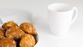 french chouquettes puffs with perles of sugar on plate with white cup of coffee. Choux pastry Classic French bakeries.