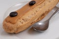 French coffee eclair on a plate closeup Royalty Free Stock Photo